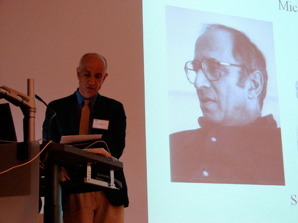 Domenico Bertoloni Meli speaks at a podium with projection of a presentation behind him